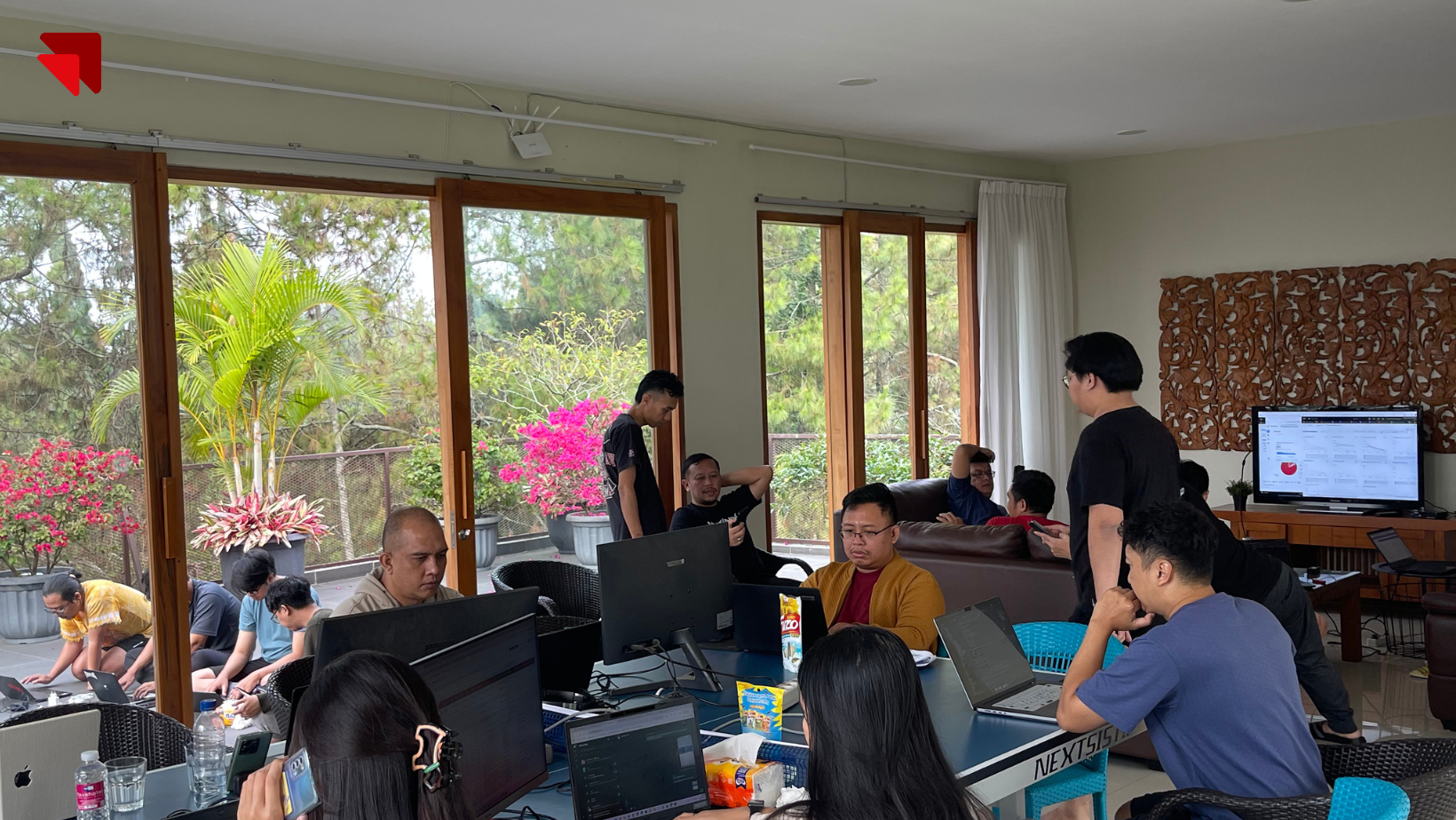 Emveep development team collaborating indoors during the BPK PENABUR Jakarta admission system project.