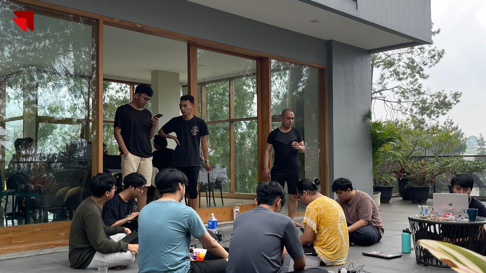 Emveep engineers working and coding outdoors during a collaborative system deployment sprint.