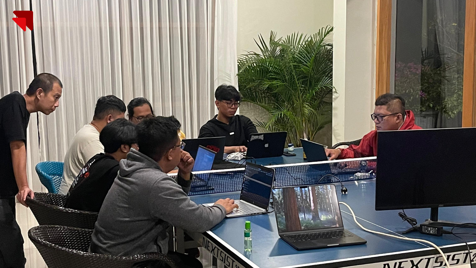Emveep developers in a focused late-night coding session, ensuring system readiness for BPK PENABUR Jakarta launch.